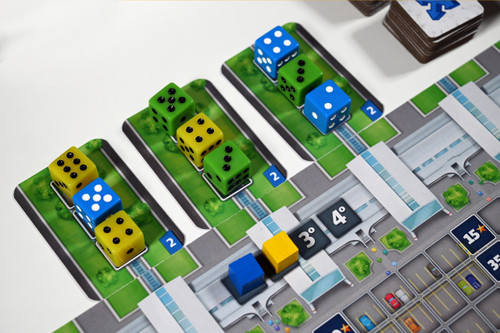 Close up of game components three dice on the board. 