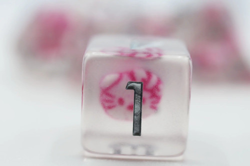 D6 close up - clear dice with white and pink kitten head inside and silver numbers. 