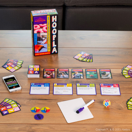 Game setup showing a number of faceup cards, tokens and a die