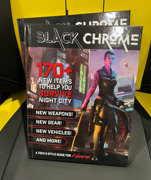 Black Chrome physical books on a gray and yellow chair
