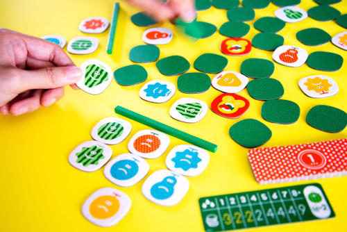 Quickity Pickity gameplay, featuring one player's fruit tiles and the forest full of fruit in the center