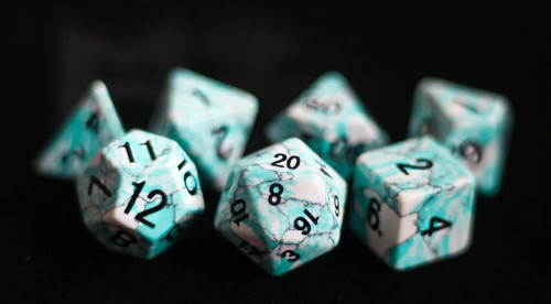 White and turquoise stone dice set with black numerals