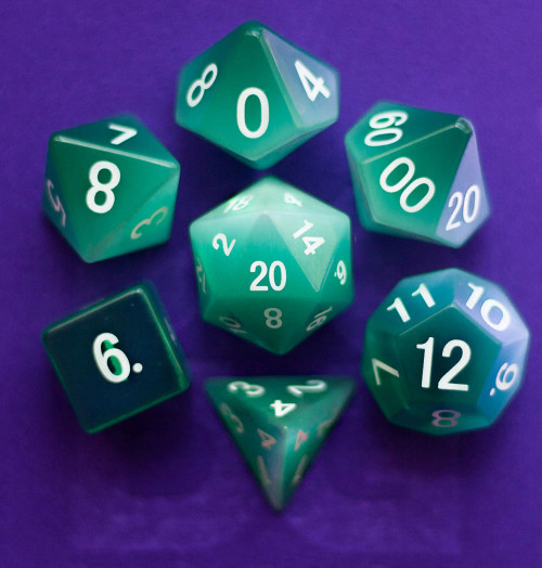 Green stone dice with white numerals