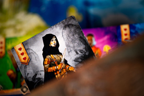 Closeup of character card showing woman in hood holding a dagger