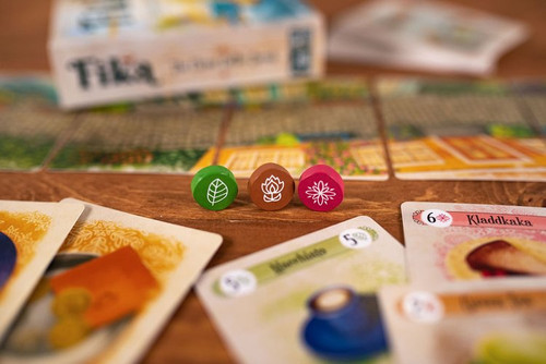 Close up of green, brown and red wooden tokens
