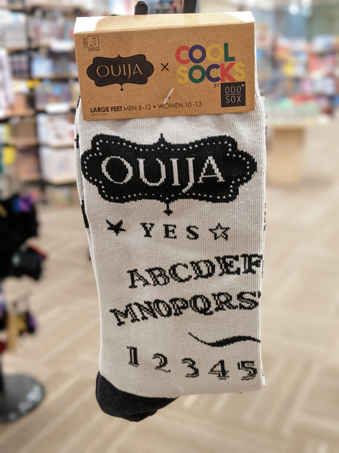 Oujia Board graphic socks on a hangar