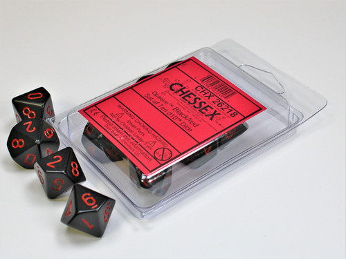 Black dice with red numbers in a plastic clamshell container