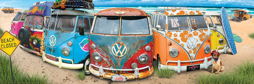 several VW vehicles lined up in bright colors on a beach