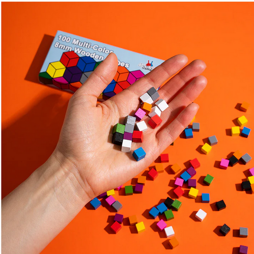 Colorful cubes in an orange surface an in a person's hand