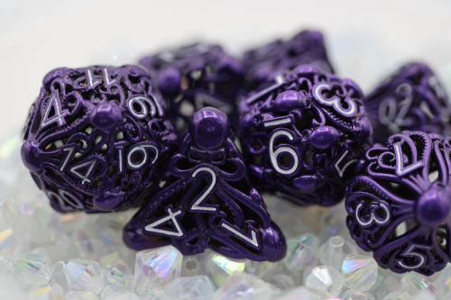 Purple metal dice with squid patterns and hollow center