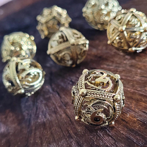 Dragon's Bauble gold dice set on a wood surface