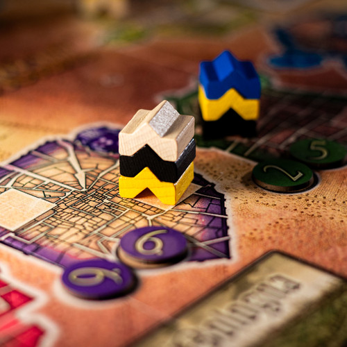 Close up of a corner of the game board, and stacked game pieces