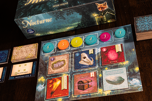 The setup of the forest grid and twilight and moonlight goals along with concoction cards and special player abilities 