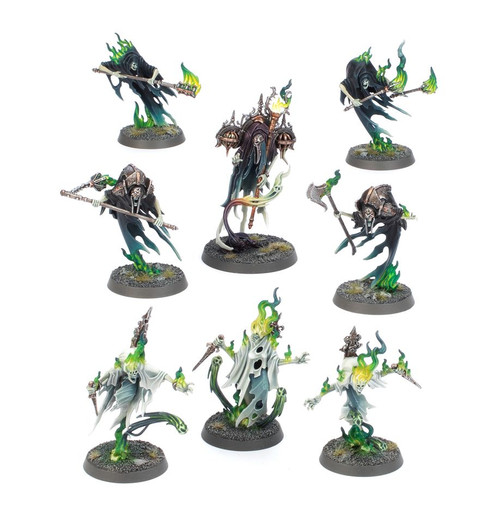 8 miniatures wearing capes and holding green fire/magic