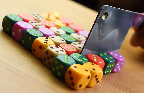 A cardboard knife cutting apart dice block