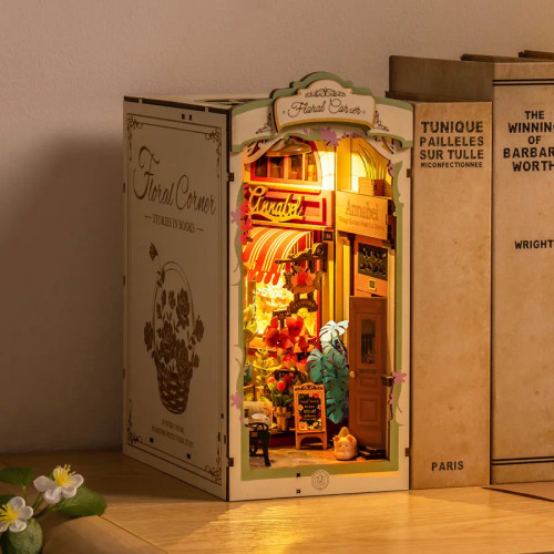 Book nook in place in a row of books, LED light glowing warmly