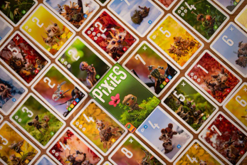 Example cards spread out around the game box
