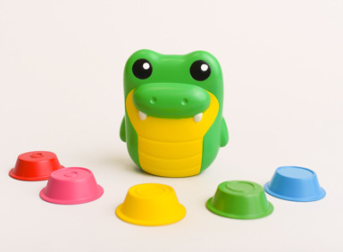 Cora alligator figure with five colorful cups/nests