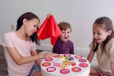 Young players play around a table