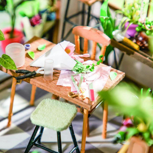 Closeup details, a florist's table with bouquets in progress