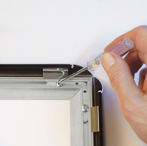 A hand assembles the frame using Phillips head a screwdriver