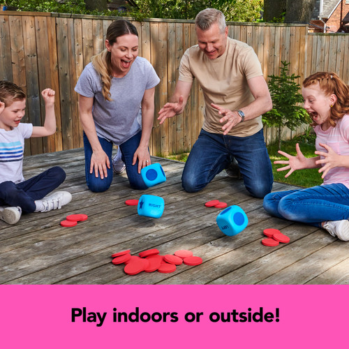 Two adults and two kids roll the giant dice outdoors