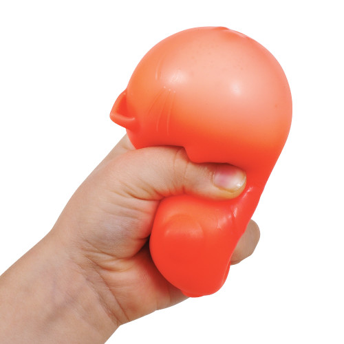 A hand squeezes a red NeeDoh Cool Cats toy