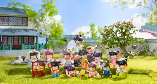 All twelve possible figurines in a grassy outdoor diorama