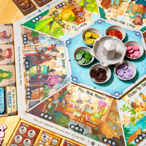 Hexagonal game board with token holders in the center