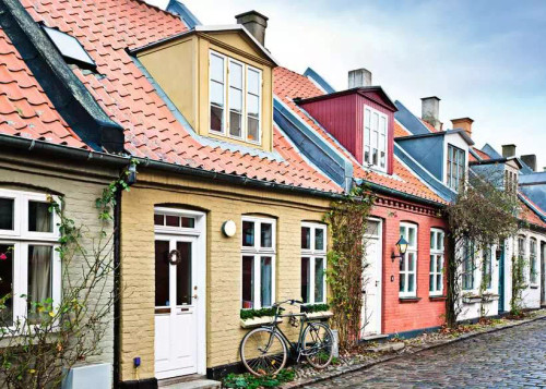 houses connected with various colors and bicycle leaning