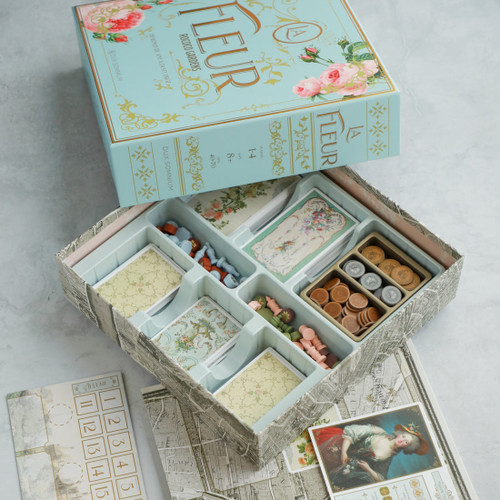 Box open with game components in beautiful compartments