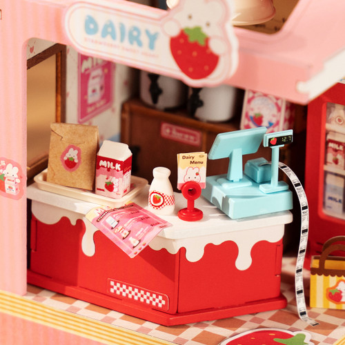 a close up of the counter with milk and a register