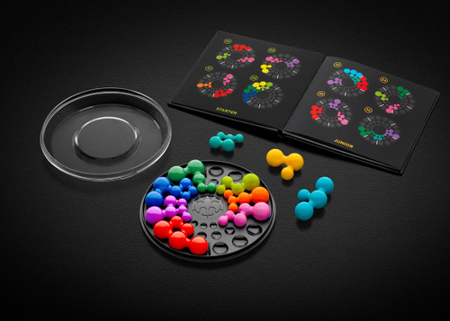 a circle with bright colored sphere pieces and a booklet of challenges
