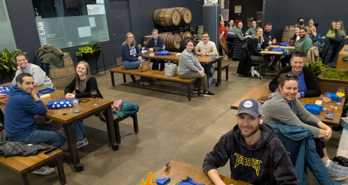Participants sit at their tables and smile before the event begins