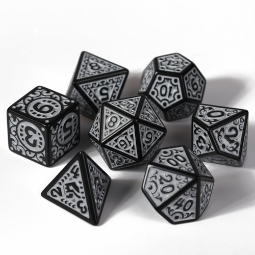 a black set of rpg dice with boarder swirls black numbers