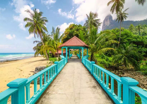 Puzzle image, depicting a beachside path with bright blue railings