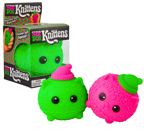 Two Knittens toys in green (with a pink hat) and pink (with a green hat) sit in front of a boxed Knitten in its window box.