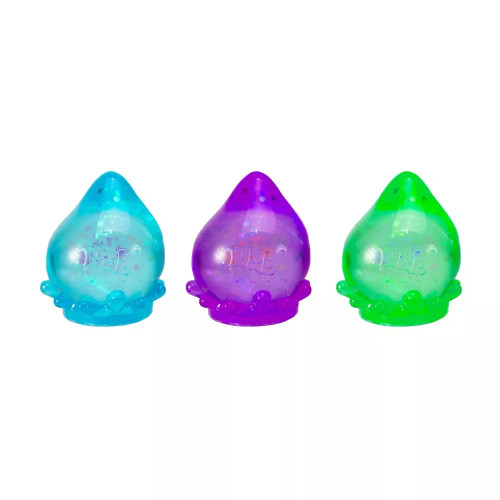 An assortment of Galactic Glow Dream Drops in a variety of colors.  There is a blue, a purple, and a green.