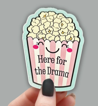 Sticker depicting a bucket of popcorn that reads "Here for the drama"