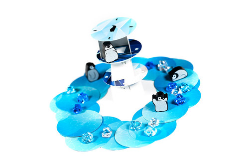 Gameplay example, with penguin tokens on a miniature tower