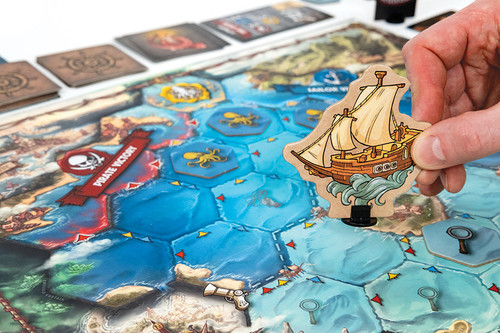a pirate ship moving along the blue water tiles