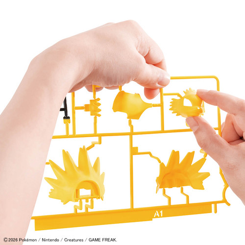 Hands remove model pieces from their plastic sprue