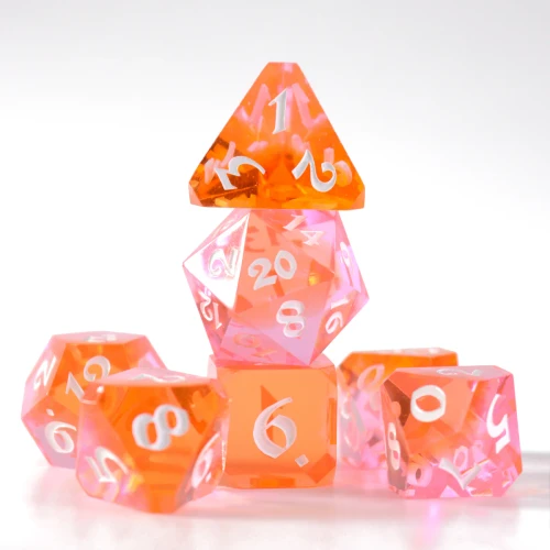 Set of 7 RPG dice in a translucent orange and pink color spectrum with refracting light patterns
