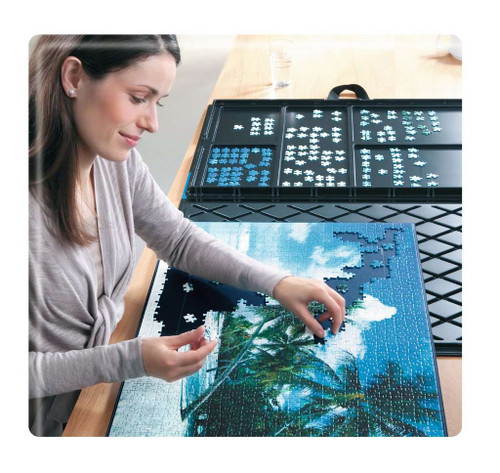 Trays and a puzzle being built by a person using the tool 