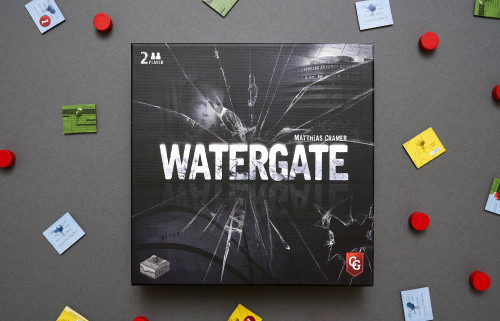 Watergate front of package, a shattered glass over a person and building and map