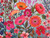 Shady Garden completed puzzle, pink and orange buds and flowers, with a mint background