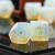 Opalite stone dice set embellished with gold, close up