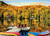 Lakeside Cottage Quebec puzzle image, depicting a lakeside cottage and chairs on a dock