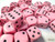 Pastel pink dice with black pips