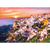 Sunset Over Santorini layout of white buildings overlooking the water